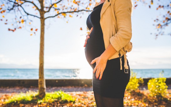 pregnant-woman-wearing-beige-long-sleeve-shirt-standing-near-brown-tree-at-daytime-132730