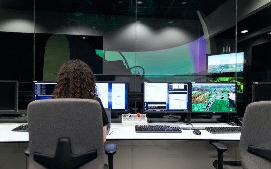 Female aerospace engineer monitors flight simulator