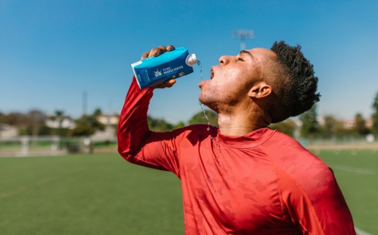 Close Up Photo of an Athlete Drinking Beverage