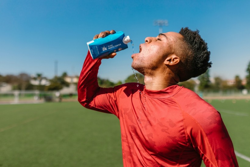 Close Up Photo of an Athlete Drinking Beverage