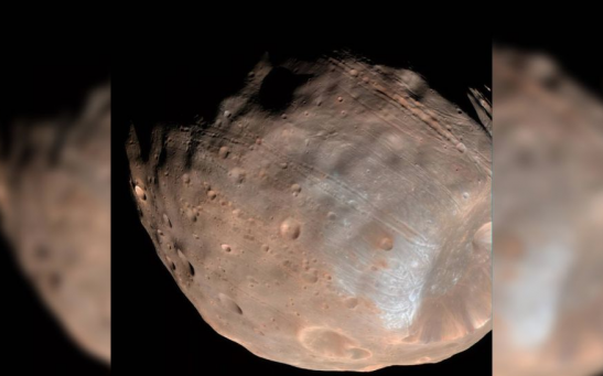 A new study has revealed that the weird parallel grooves on the surface of Mars' largest moon Phobos could be a sign that the Red Planet's gravity is ripping the satellite apart.