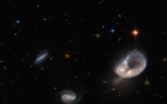  Hubble Space Telescope Captures Glowing Ring of Stars From a Pair of Entwined Galaxies