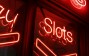 red and white neon light slots signage