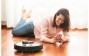 woman with a robotic vacuum cleaner