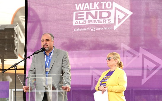 Bankers Life Regional Director Farshad Asl and Alzheimers Association California Southland Chapter Executive Director Breena Gold speak onstage during the Walk to End Alzheimer's Los Angeles.